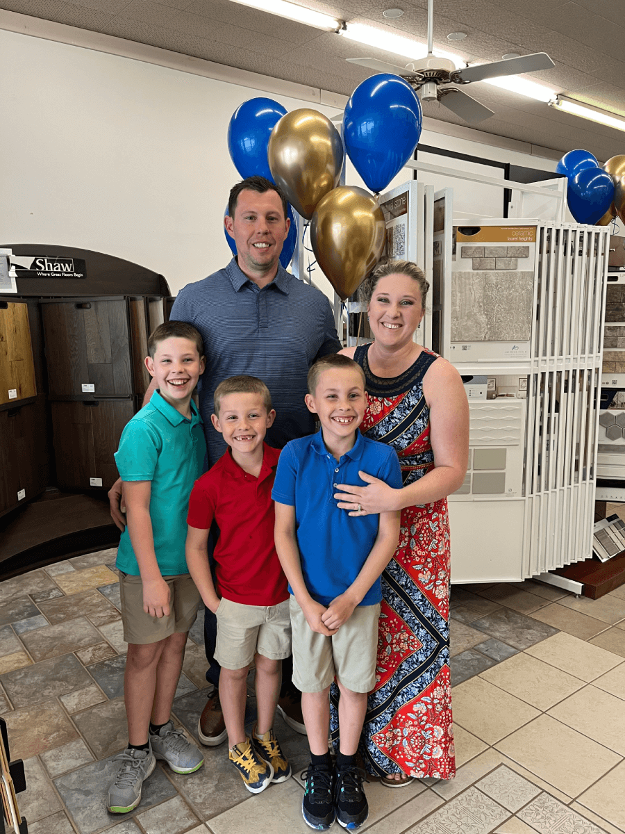 Forrest and Amber Boisse in their showroom with their three sons | F & A Flooring